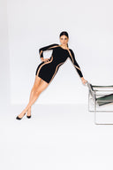 Front view of the Room 24 Becca black mini dress with long sleeves and curved sheer-mesh panels framing the shoulders and waist.