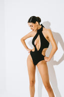 Side view of the Room 24 Adriana one-piece highlighting its waist cut-outs, sculpted fit and high-cut leg.