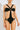 Front view of the Room 24 Camilla black one-piece swimsuit with a bandeau-inspired bust, centre ring detail and curved waist cut-outs.