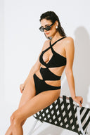 Side view of the Room 24 Jennifer one-piece swimsuit highlighting its curved waist cut-outs and high-cut leg.