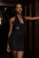 Side view of the Room 24 Denise black bodysuit showing its open-side detailing, plunge neckline and body-contouring silhouette.