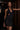 Side view of the Room 24 Denise black bodysuit showing its open-side detailing, plunge neckline and body-contouring silhouette.