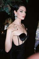 Front view of the Room 24 Emily black corset maxi dress with underwired cups, one long glove sleeve and a thigh-high split.
