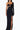 Front view of the Room 24 Emily black corset maxi dress with underwired cups, one long glove sleeve and a thigh-high split.