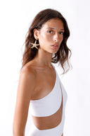 Side view of the Room 24 Freya white one-piece highlighting its curved illusion-mesh panels and high-cut leg.