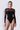 Front view of the Room 24 Melis bodysuit with long mesh sleeves, a sheer shoulder panel and curved waist detailing.