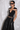 Side view of the Room 24 Rosy Top showing its deep neckline, sheer shoulder panel and body-contouring fit.