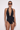 Generated_with_Kive.ai_-_Replace_the_current_patterned_swimsuit_with_the_exact_black_Chloe_halter_one-piece_from_the_reference_image._Preserve_the_model_s_identity__face__hair__sunglasses__earrings__bracelets__pose__body_proportions__crop__