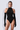 Front view of the Room 24 Giana Bodysuit featuring a high halterneck, sleeveless design, tonal animal pattern and high-cut leg.