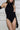 Side view of the Room 24 Grace black bodysuit showing its smooth, body-contouring fit and detachable gloves.