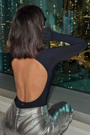 Back view of the Room 24 Jane black bodysuit highlighting its dramatic open back and sculpted thong silhouette.