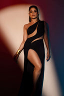 Side view of the Room 24 Joanna black maxi dress highlighting its curved waist cut-outs, body-contouring fit and high leg split.
