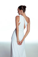 Back view of the Room 24 Joanna white cut-out dress showing its asymmetric shoulder construction and sculpted full-length silhouette.