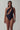 Front view of the Room 24 Louise one-piece swimsuit with an asymmetric neckline, sweeping cut-out and chain detailing.