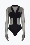 Close-up of the Room 24 Maria black bodysuit showing the deep V-neck trim, front zip and sheer mesh construction.