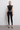 Front view of the Room 24 May Top featuring a high collar, sheer mesh panels, sculptural neckline cut-outs and beaded knot fastenings.