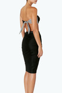 Back view of the Room 24 Mia skirt showing its smooth waist and close-fitting midi silhouette.
