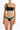 Woman wearing a black one-shoulder bikini with green and blue accents