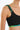 Close-up of black crop top with braided green and blue straps, sustainable fashion