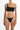 Woman wearing a black one-shoulder bikini with woven strap details, front view