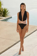 Front view of the Room 24 Rachel one-piece swimsuit with a deep plunge neckline, gathered halterneck and crossover waist.