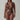 Woman modeling metallic bronze bodysuit with deep V-neck and cut-out style, fashion studio shot