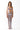 Woman wearing sheer mesh maxi dress with asymmetric cutouts over a metallic bikini, white background