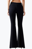 Back view of the Room 24 Gia trousers highlighting their fitted silhouette and floor-length flared legs.