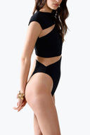 Side view of the Room 24 Clara black bodysuit highlighting its asymmetric draping and waist cut-out.