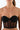 Woman wearing a strapless black mesh corset top with underwire details