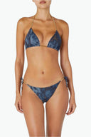 Woman wearing blue tie-dye bikini with gold chain straps, front view on white background