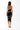 Back view of the Room 24 Sienna black strapless dress highlighting its wraparound mesh panels and fitted midi silhouette.