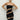 Front view of the Room 24 Sienna black strapless midi dress with diagonal illusion-mesh panels and a sculpted bodycon fit.