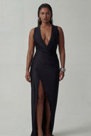 Front view of the Room 24 Silvy black maxi dress with a deep plunge neckline, draped wrap waist and centre slit.