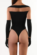 Back view of the Room 24 Solera black mesh bodysuit highlighting its long sleeves and streamlined thong silhouette.