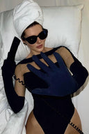 Close-up of the Room 24 Solera black bodysuit showing the boat neckline and contrasting sheer mesh yoke.