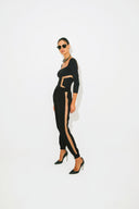 Side view of the Room 24 Taylor black bodysuit showing its illusion-mesh waist panel and sculpted body-contouring fit.