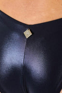 Close-up of the Room 24 Fanny one-piece swimsuit showing its plunge neckline and smooth stretch-fabric construction.