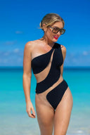 Front view of the Room 24 Freya black one-piece swimsuit with an asymmetric shoulder and sweeping illusion-mesh cut-outs.