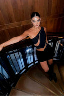 Side view of the Room 24 Freya black one-piece highlighting its curved illusion-mesh panels and high-cut leg.