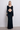 Front view of the Room 24 Bella black reversible maxi dress styled with a twisted V-neckline, curved waist cut-out and long sleeves.