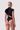 Back view of the Room 24 Clara black bodysuit showing its high neckline, cap sleeves and close-fitting silhouette.