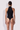 Back view of the Room 24 Lara black halterneck bodysuit with a high collar and vertical ladder-style chest cut-outs.