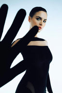 Side view of the Room 24 Samantha black velvet maxi dress highlighting its body-contouring fit and dramatic thigh-high split.