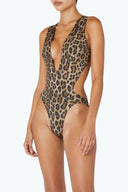 Side view of the Room 24 Fanny one-piece swimsuit highlighting its curved waist cut-outs and body-contouring silhouette.